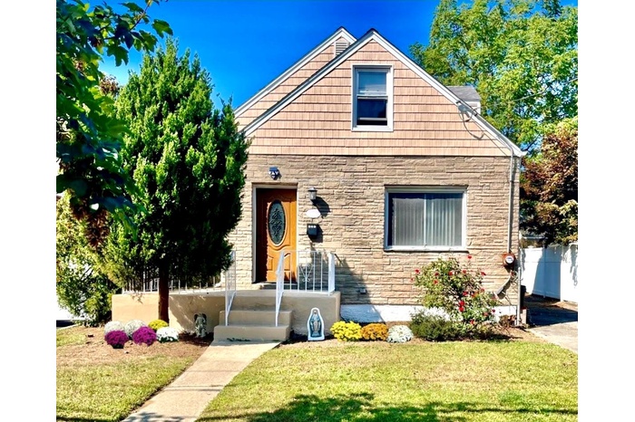 View of front of house with stone siding