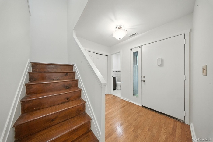 Entrance foyer featuring wood finished floors and stairway
