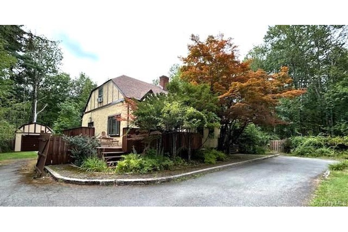 View of side of home with a  wooden deck