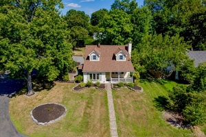 Step into this storybook Cape Cod filled with warmth, light and timeless charm.