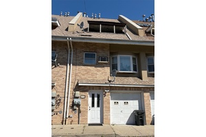 2 family attached brick with a 1 car built in garage.