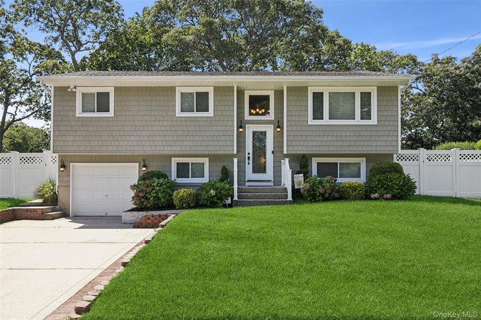 Bi-level home with a garage and driveway