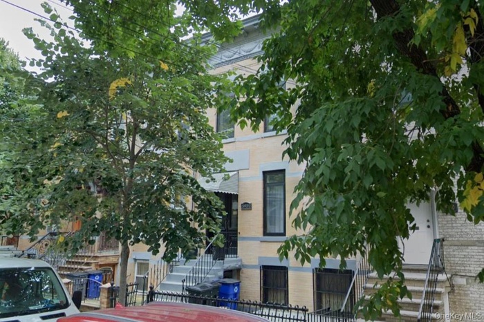 View of front of home with brick siding and stairs