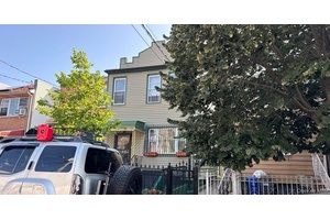 This Duplex Style Home Features 5 Bedrooms, 2 Full Baths, 2 Eat In Kitchens and Basement.