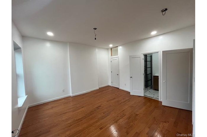 Basement with wood finished floors and recessed lighting