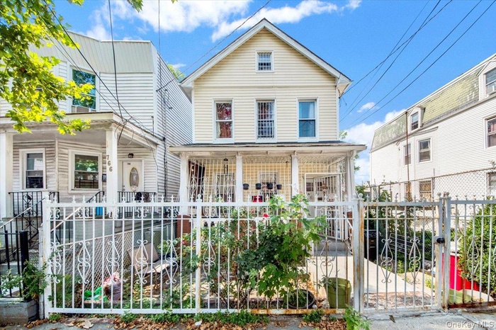 View of front of home featuring a fenced front yard and a gate