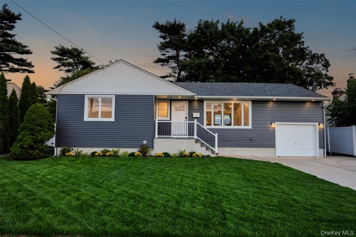 Ranch-style home featuring concrete driveway, a front lawn, and a garage