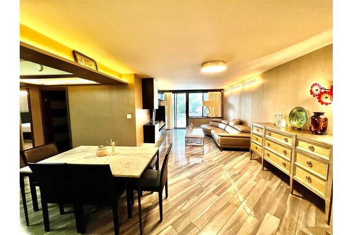 Dining area with light wood-type flooring and a wall of windows