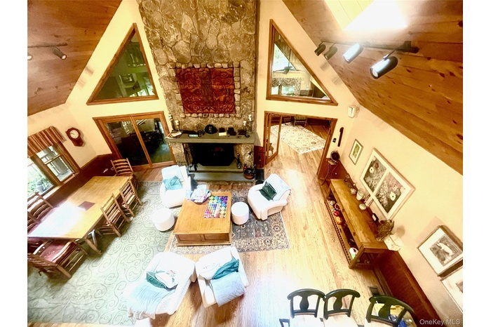 Living area featuring wooden ceiling, wood finished floors, and high vaulted ceiling