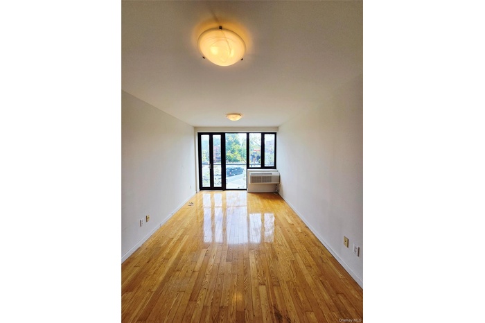 Spare room featuring light wood-style floors and baseboards