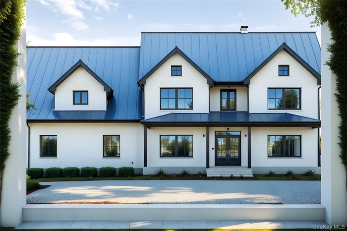 Back of property featuring a standing seam roof, french doors, a metal roof, and stucco siding