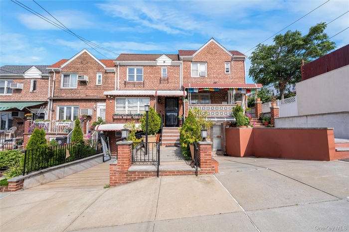 Traditional home featuring brick siding, a fenced front yard, driveway, a gate, and a residential view