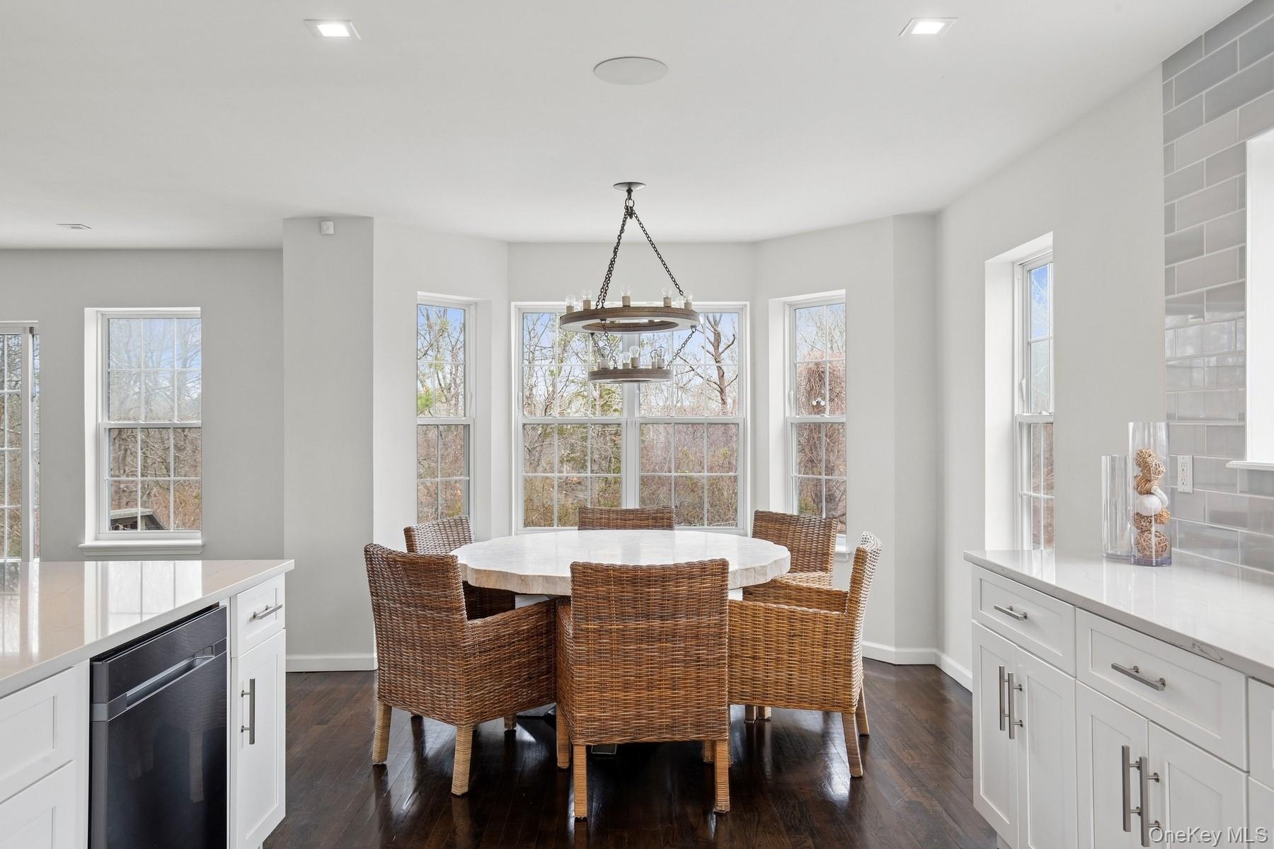 Dining space with recessed lighting, baseboards, and dark wood finished floors