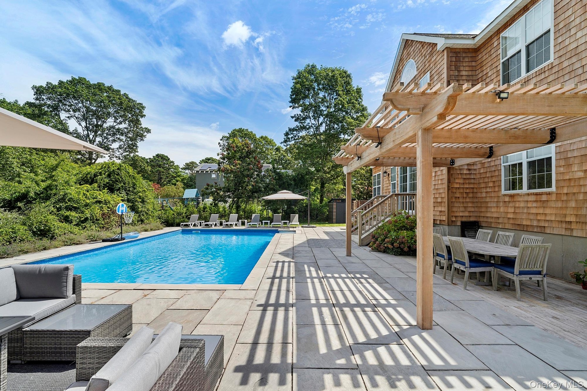 View of swimming pool featuring a patio area, a pergola, and outdoor dining space