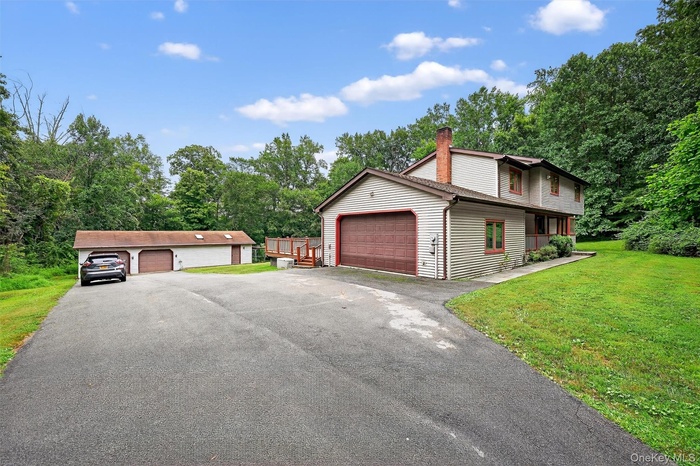 Centerhall Colonial with 4 garage parking spots and over 3 acres land.