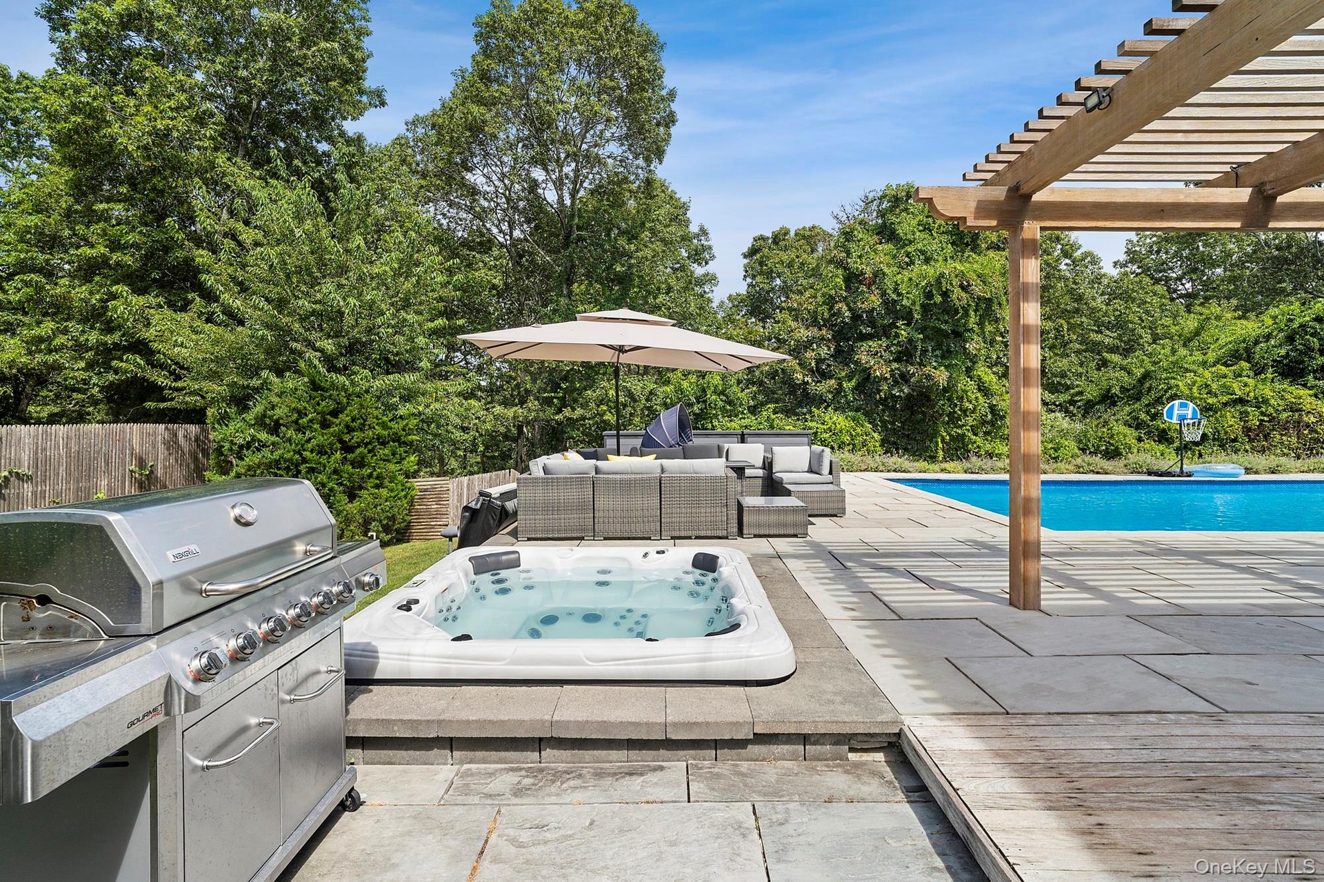 View of patio with an outdoor hot tub, an outdoor living space, a grill, a pergola, and an outdoor pool