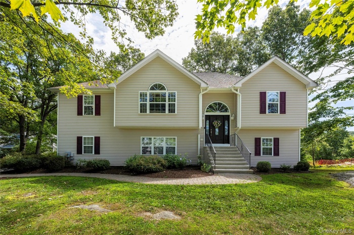 Split foyer home with a front lawn