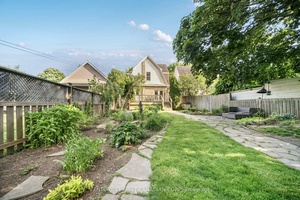 This incredibly well kept yellow brick century home sits on a deep lot on a quiet, tree lined street.
