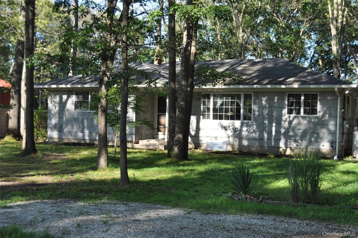 Single story home with a front lawn