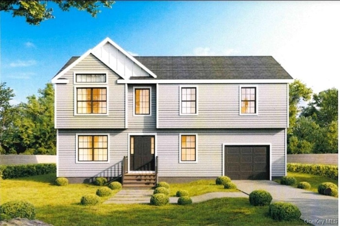 View of front of house featuring a garage, driveway, a front yard, and board and batten siding