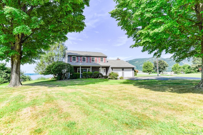 View of front of home featuring an attached garage and front yard