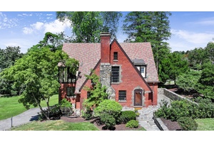Step into this charming 1930 Tudor style home in the heart of Poughkeepsie, where timeless character meets generous living space.