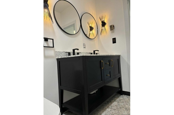 Half bath featuring double vanity and toilet