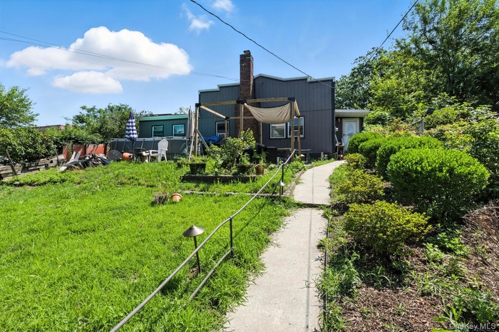 Back of house featuring a chimney