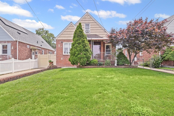 View of front of house featuring brick siding