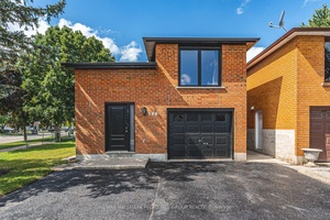 MODERNIZED RAISED BUNGALOW WITH TWO SELF CONTAINED LIVING AREAS OFFERING IN LAW POTENTIAL !