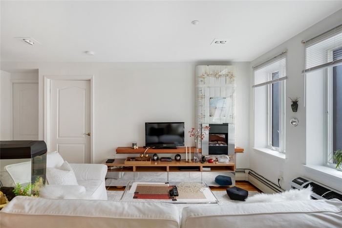 Living area with a baseboard radiator and wood finished floors