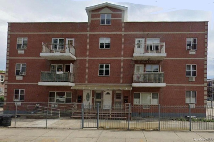 View of apartment building / complex featuring a fenced front yard