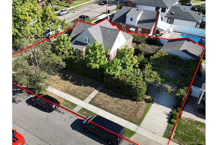 Aerial view of residential area with property boundaries highlighted