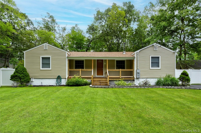 Single story home featuring covered porch and roof with shingles