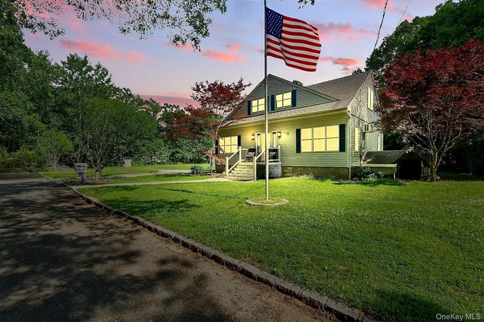 View of front facade with a yard and a porch