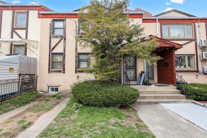 Townhome / multi-family property featuring brick siding