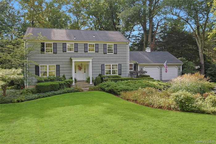 Colonial house featuring beautiful yard