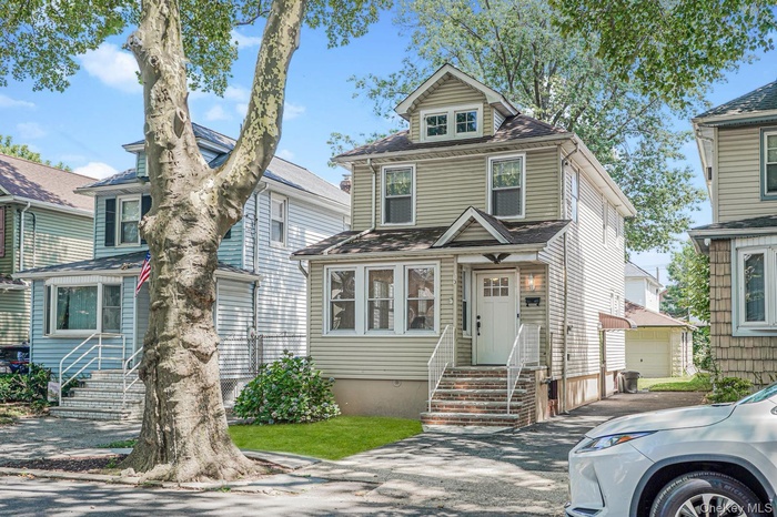American foursquare style home with a shingled roof