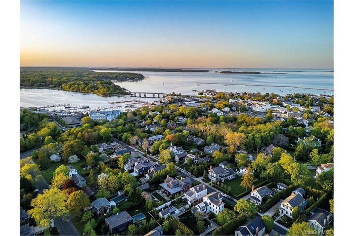 Aerial view at dusk of a notable bridge, a residential view, and a water view