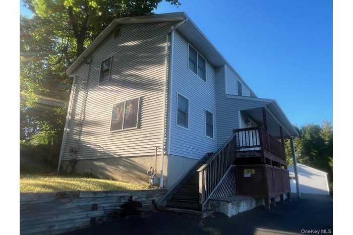 View of side of home featuring stairs