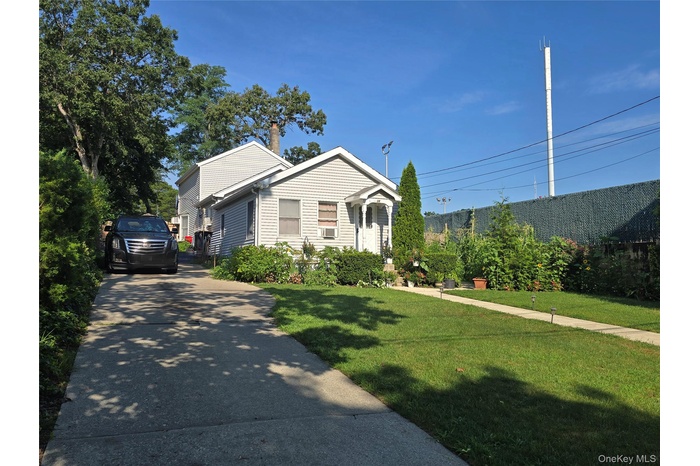 View of front of property with driveway and a front yard