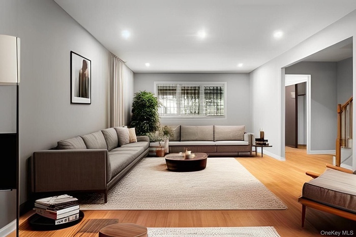 Living room featuring light wood finished floors, recessed lighting, and stairs
