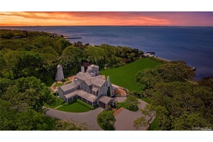 This majestic, one of a kind estate is set on 4 private, resort like acres south of Montauk Highway.