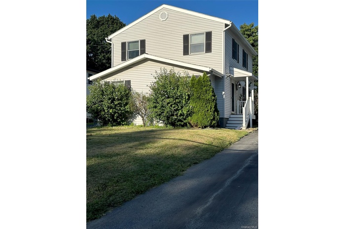 View of property exterior featuring a yard