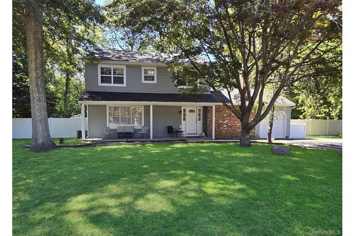 Traditional-style house featuring concrete driveway
