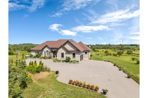 Experience the perfect blend of luxury and country living in this stunning all stone bungalow with a walk out basement and expansive backyard deck, set on a picturesque 40 acre ...