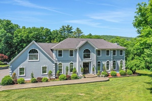 Beautiful custom built Colonial home located in a prestigious neighborhood of higher end luxury homes surrounded by privacy and nature at the end of a cul de sac.