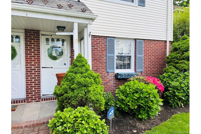 Doorway to property with brick siding