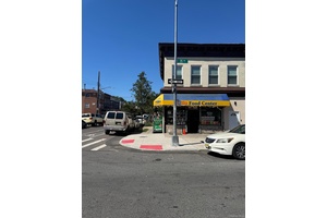 Corner Property featuring a rented storefront bodega no lease on the first floor and a fully renovated, vacant 3 bedroom apartment on the second floor.