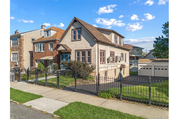 View of front facade featuring a fenced front yard and brick siding